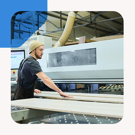 A man operating machinery in a factory setting.