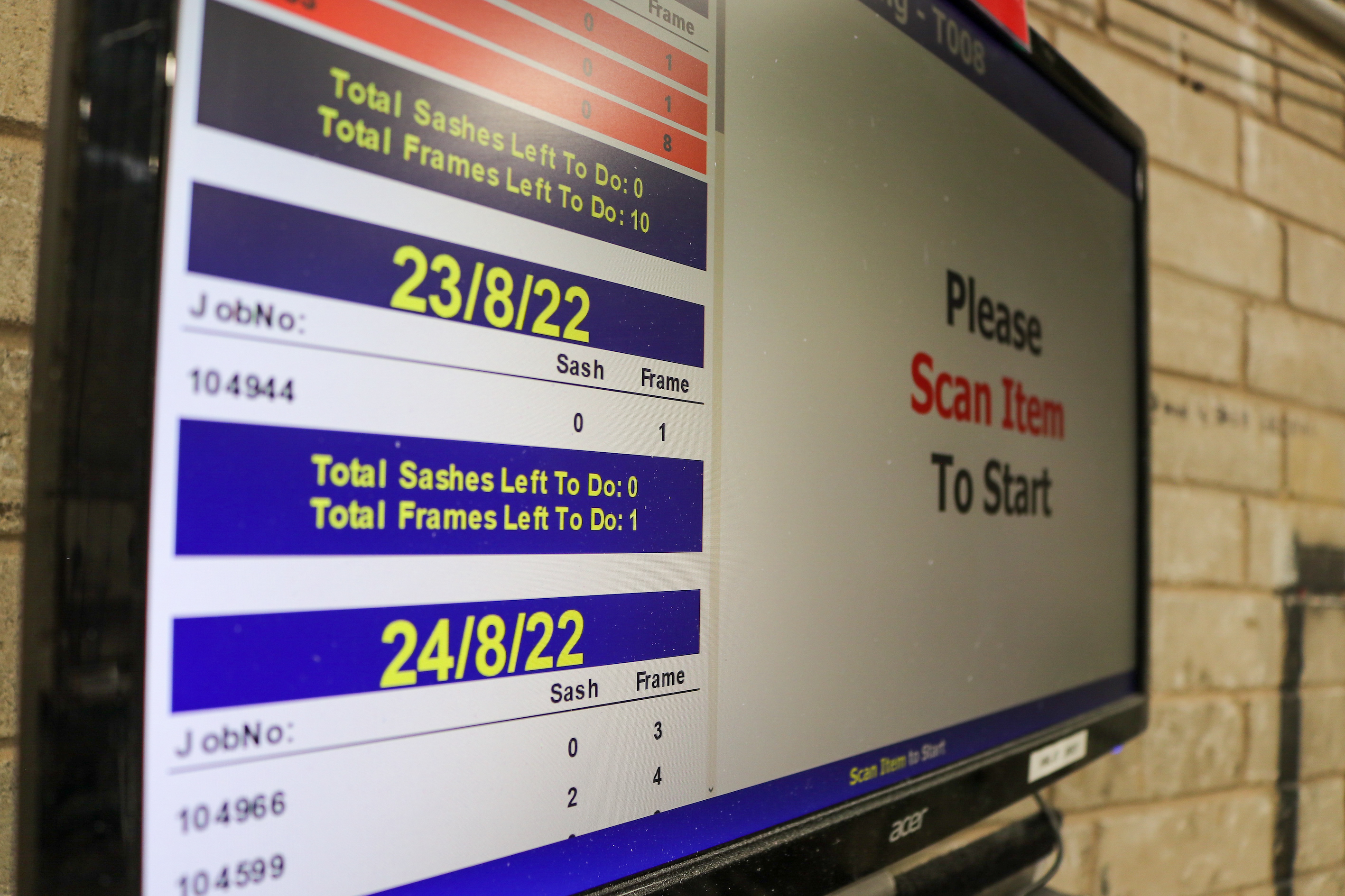 A digital screen displaying job information for a window and sash manufacturing process. The screen shows job numbers, total sashes left to do, and total frames left to do with dates of 23/8/22 and 24/8/22.