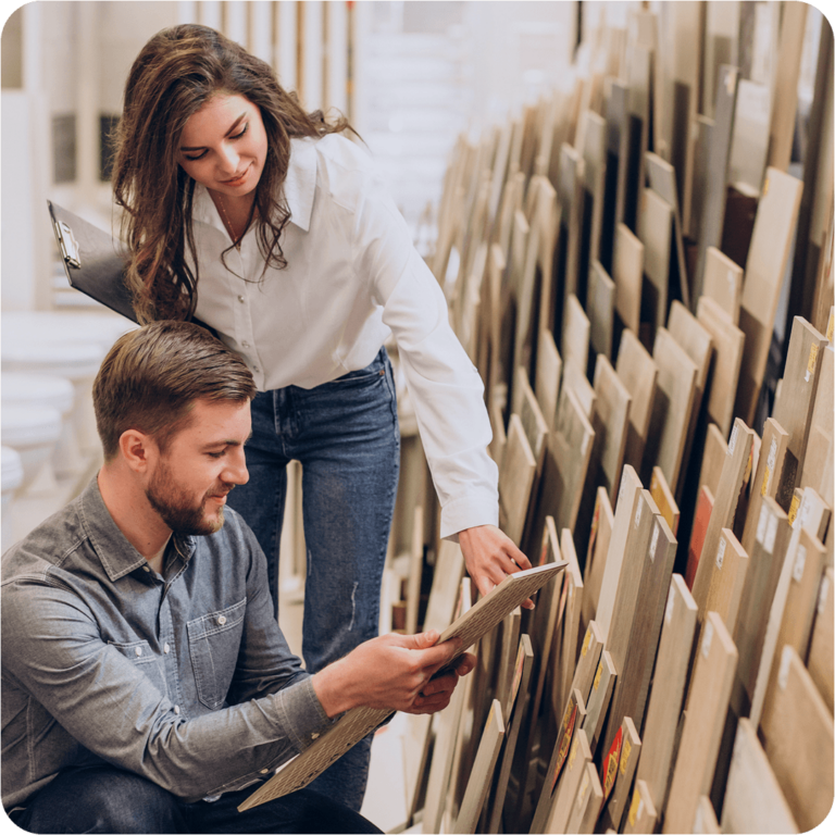 A man and woman examining wood panels.