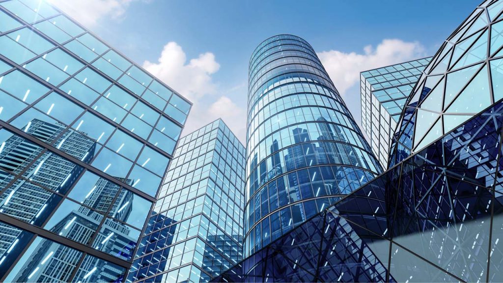 Modern cityscape with tall buildings featuring blue glass exteriors.