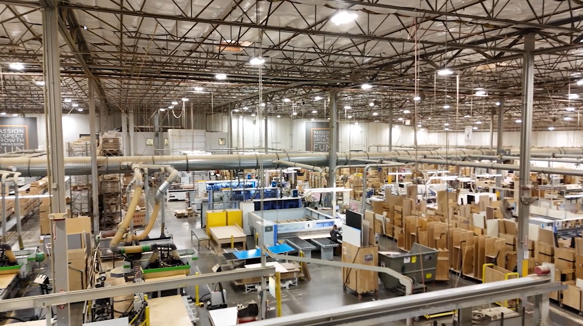 Interior view of Bellmont Cabinet Company's warehouse in Sumner, Washington, showcasing the scale of production with materials and cabinetry stored across the expansive facility.