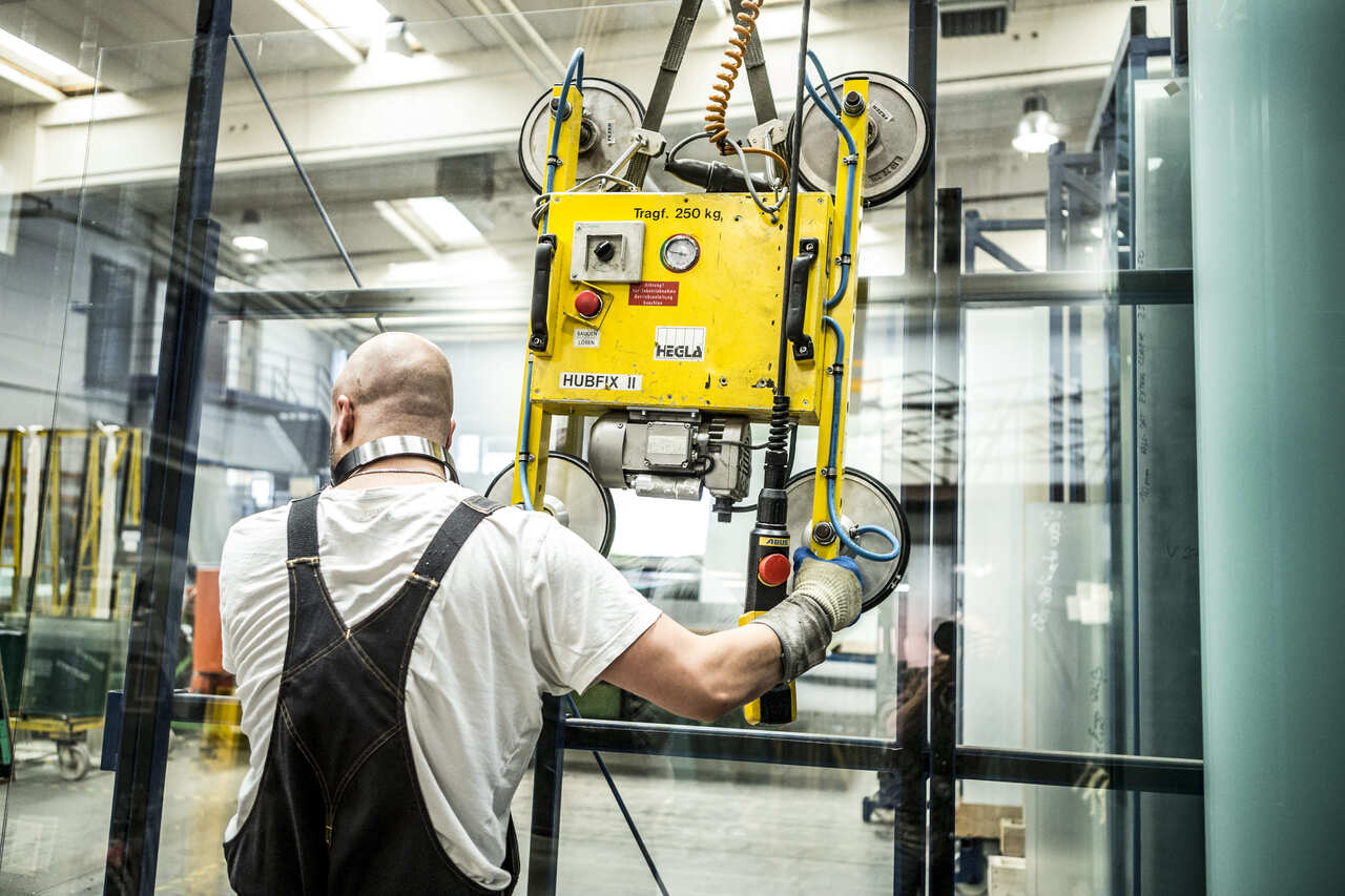 A man is holding a yellow machine