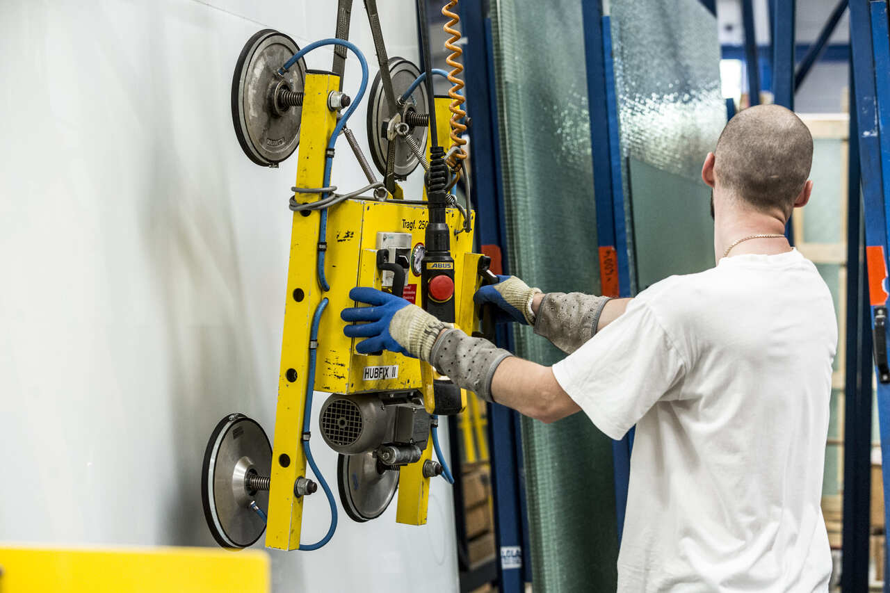 A man operates a machine in a factory