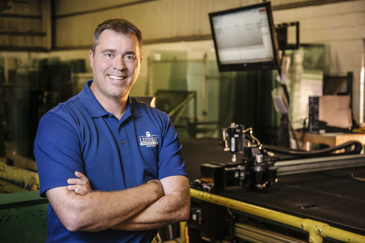 A man stands in front of a machine