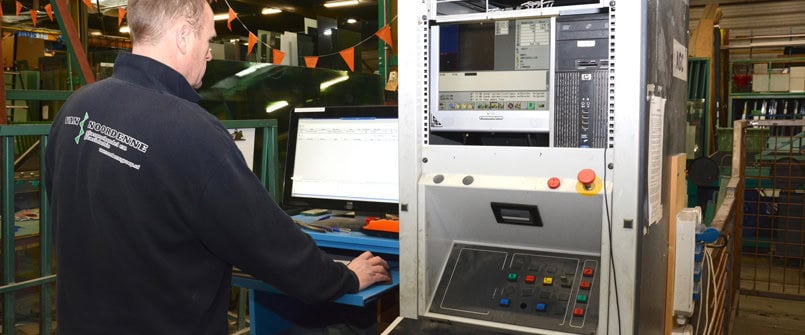 A factory worker operating a computer