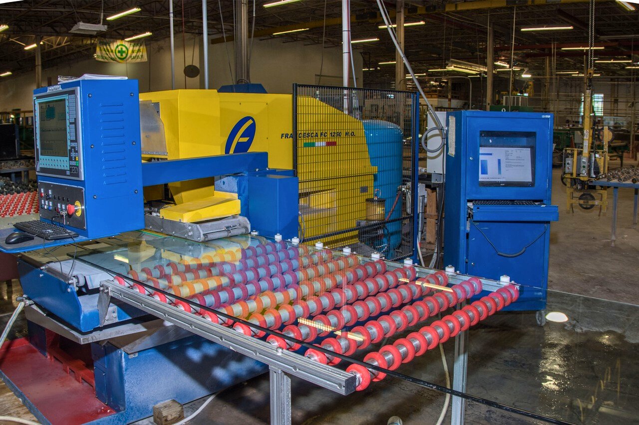 An industrial machine creating glass in a factory setting