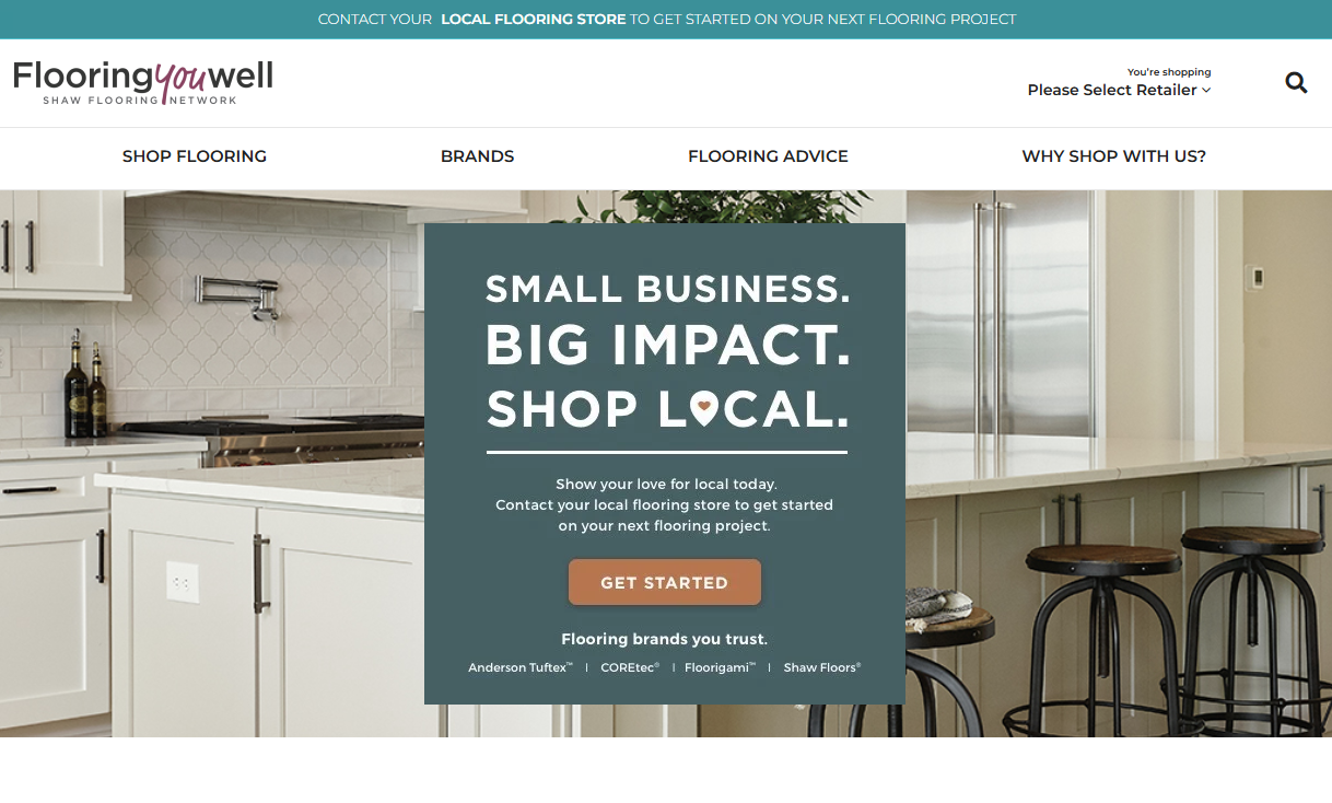 Flooring you well - homepage.png: A modern kitchen with white cabinetry, a stainless steel refrigerator, and bar stools at a white countertop island, featuring a promotional message: 'Small business. Big impact. Shop local.' encouraging users to contact their local flooring store for projects.