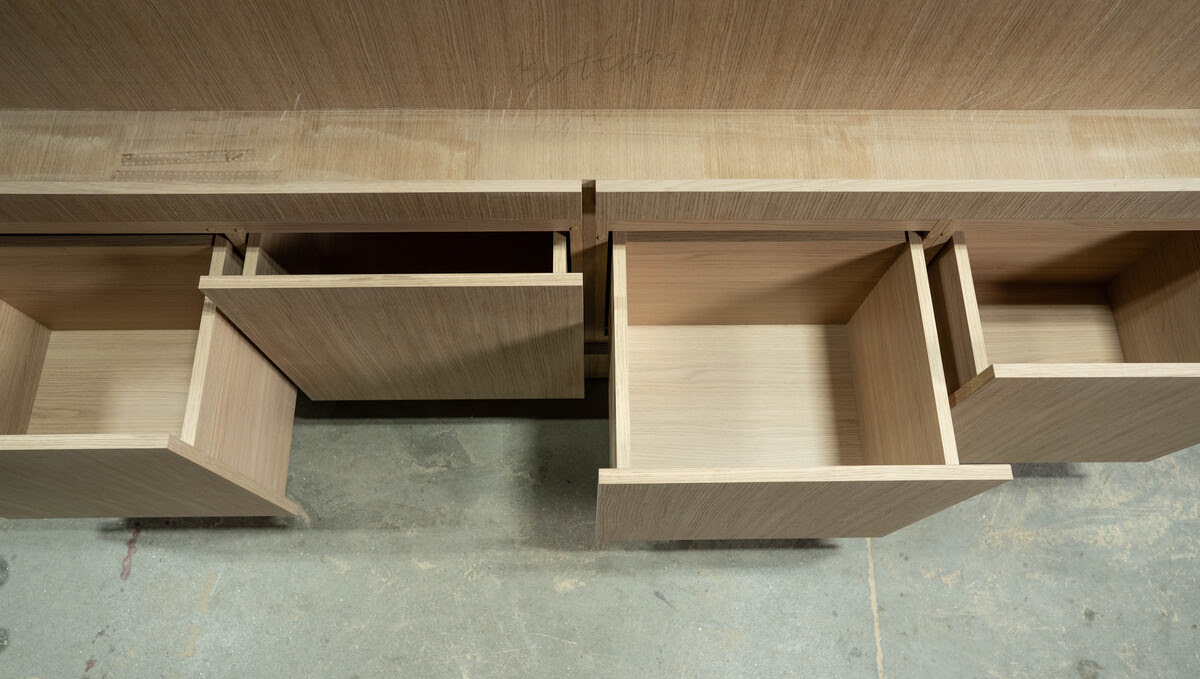 A wooden desk featuring drawers