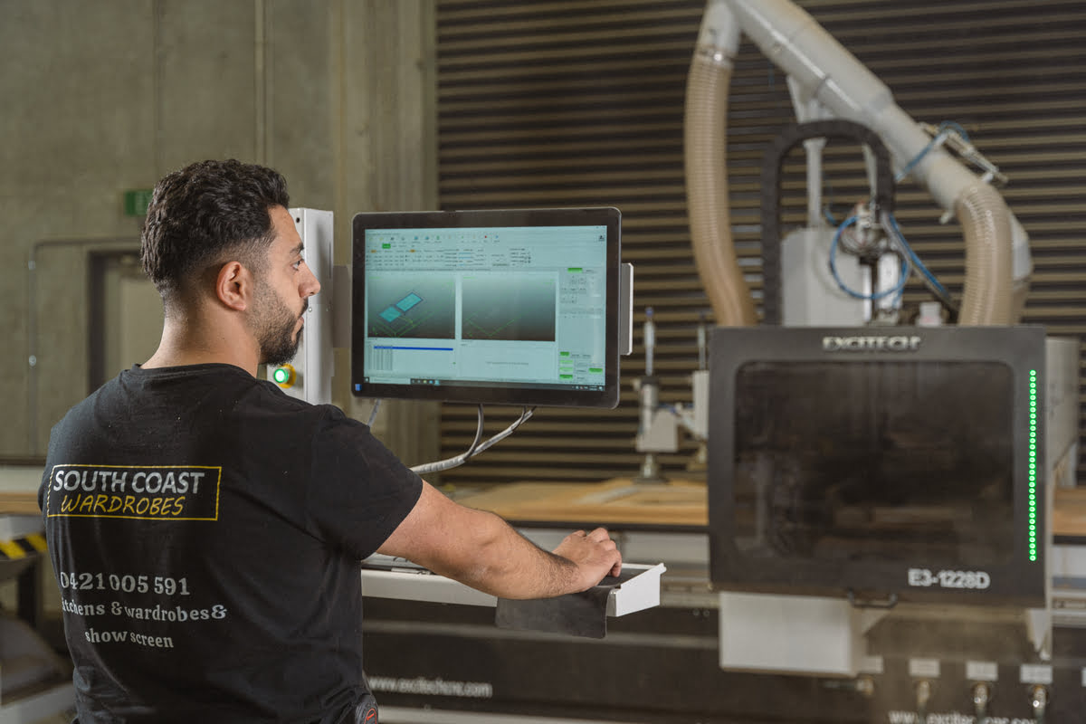 A man operates machinery in a factory setting