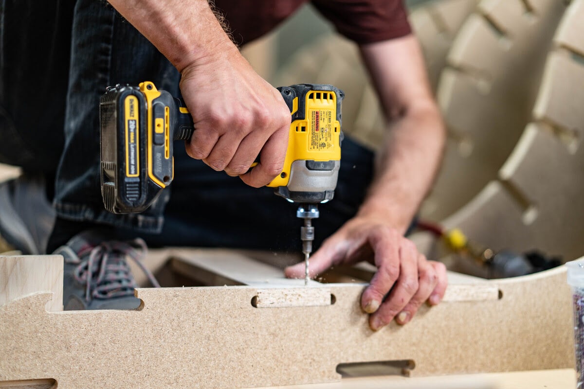 A man operates a drill