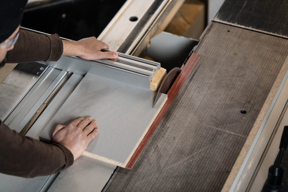 A man operates a table saw