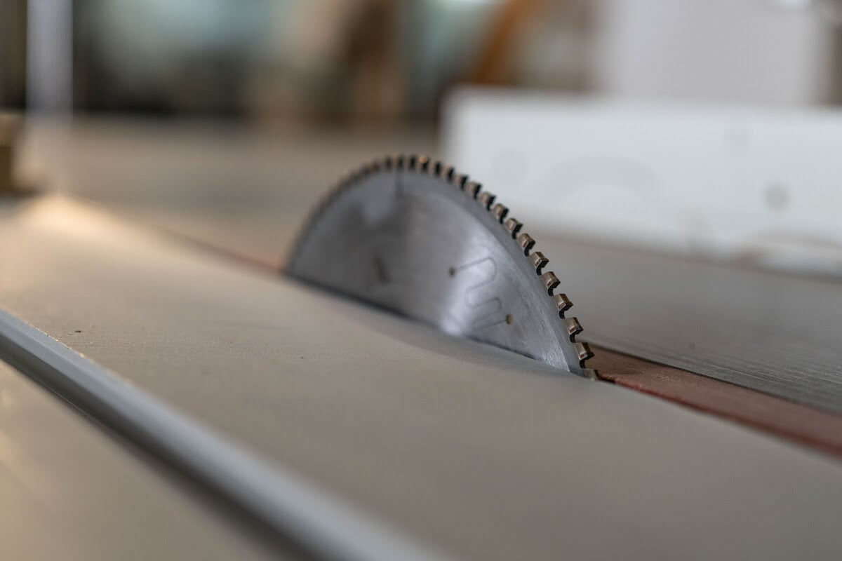 A saw blade rests on a wooden table